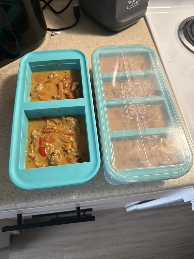 A prepared meal divided into Souper Cubes compartments for freezing.